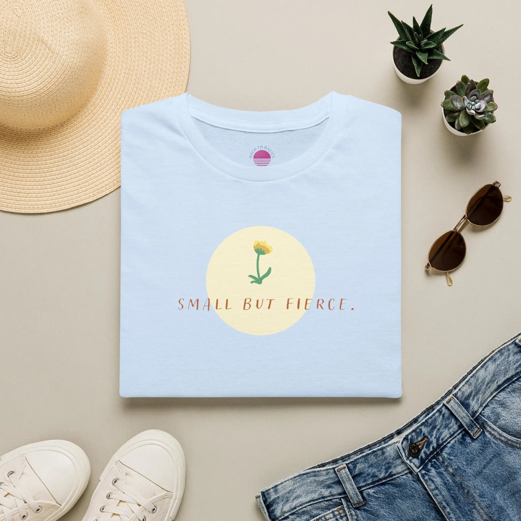 Small But Fierce Women's Minimalist T-Shirt laid flat with floral design on light blue fabric.