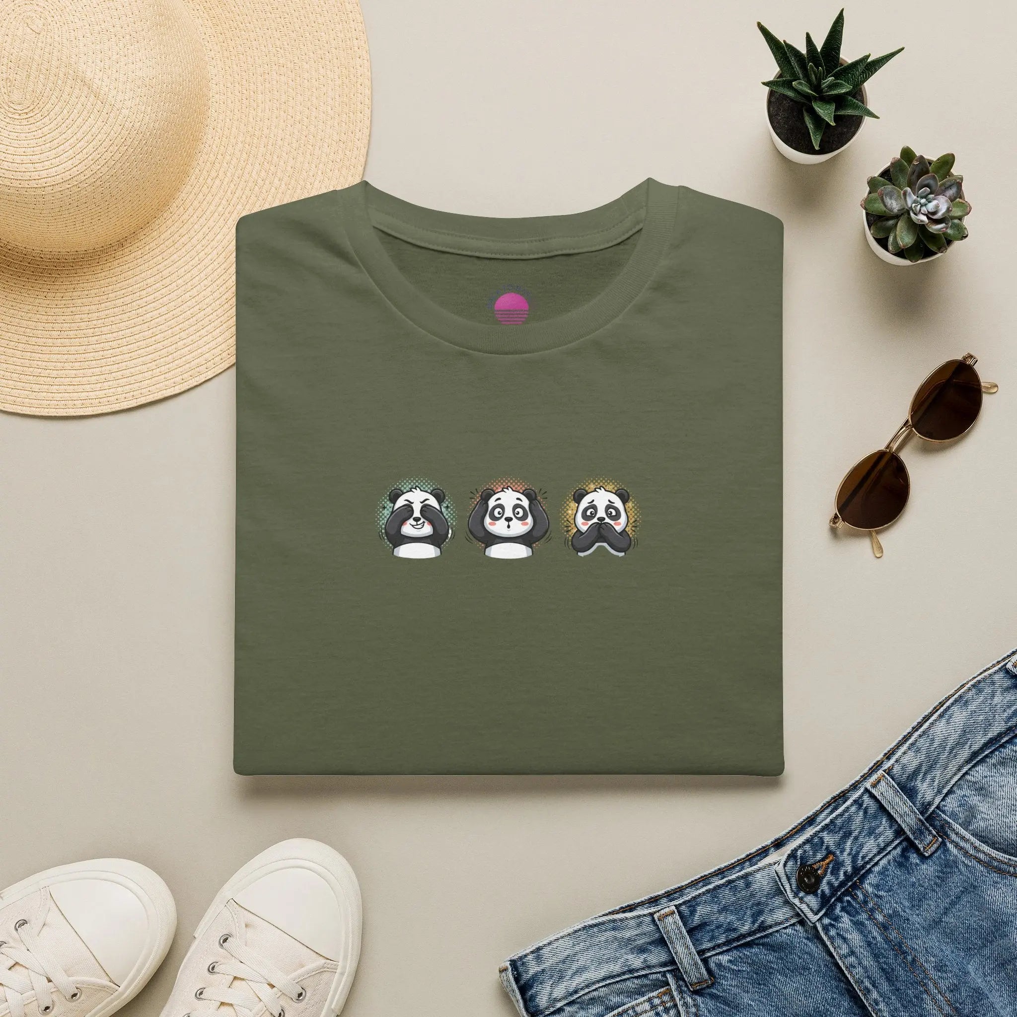 Panda Trio graphic t-shirt featuring cute cartoon panda faces on a green tee.