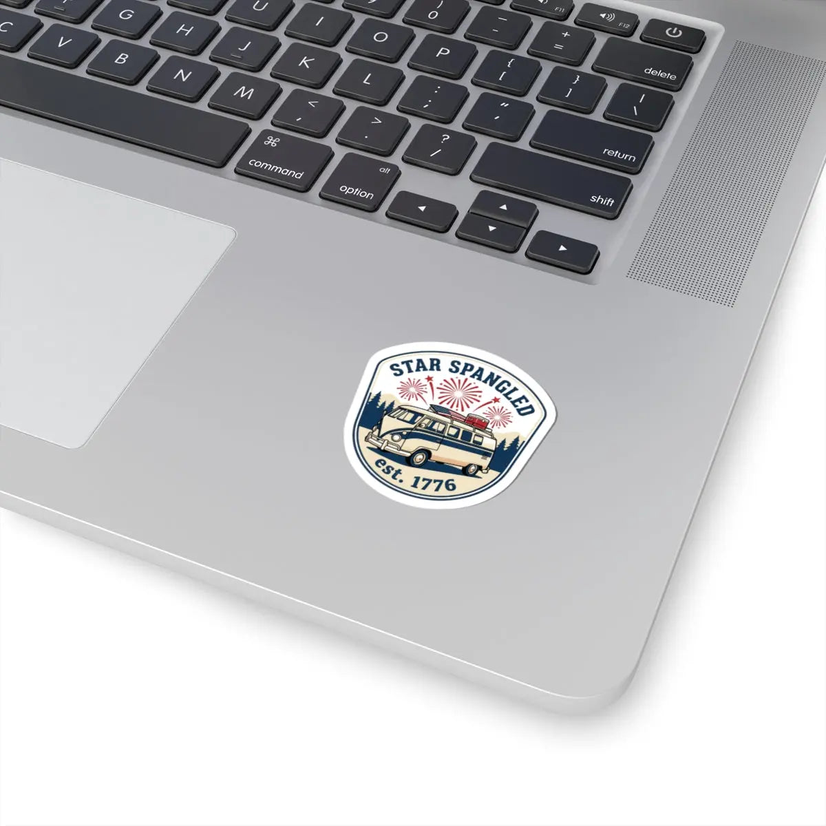 custom kiss-cut stickers on a laptop featuring a 'Star Spangled' design with fireworks and a vintage vehicle.